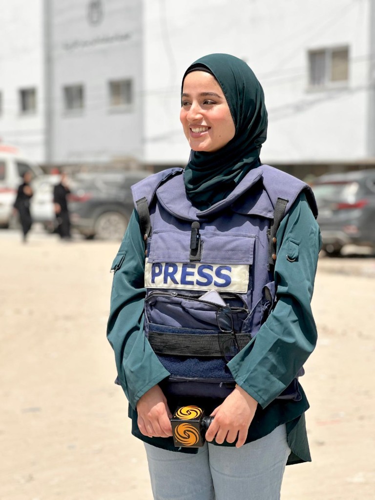 Nour Elassy smiling in press gear